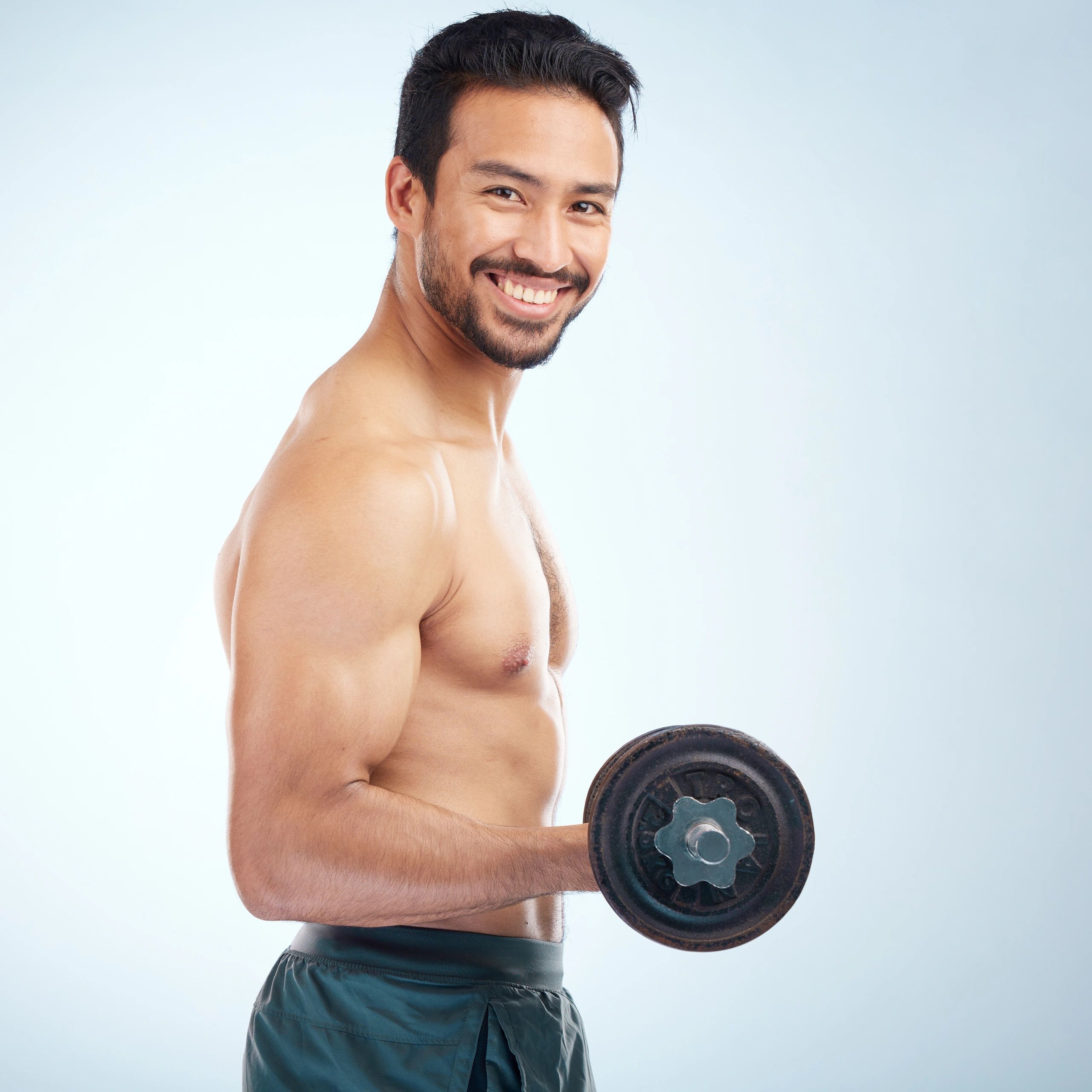 Portrait of a male coach holding a dumbbell