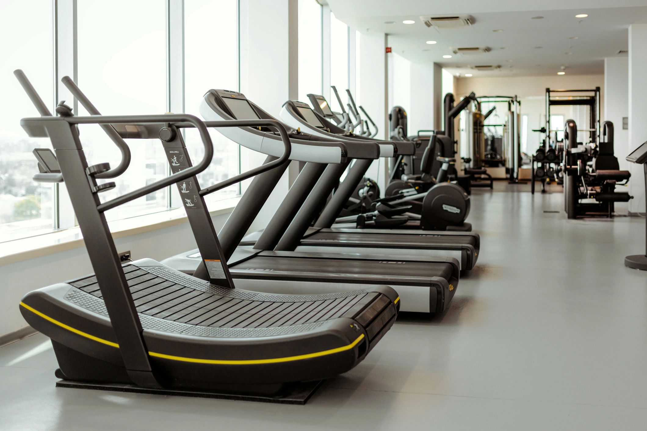 Modern gym cardio equipment in a bright training facility